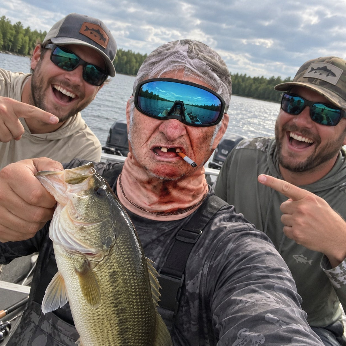 Buddies laughing at Grumpy Gus mask on the boat